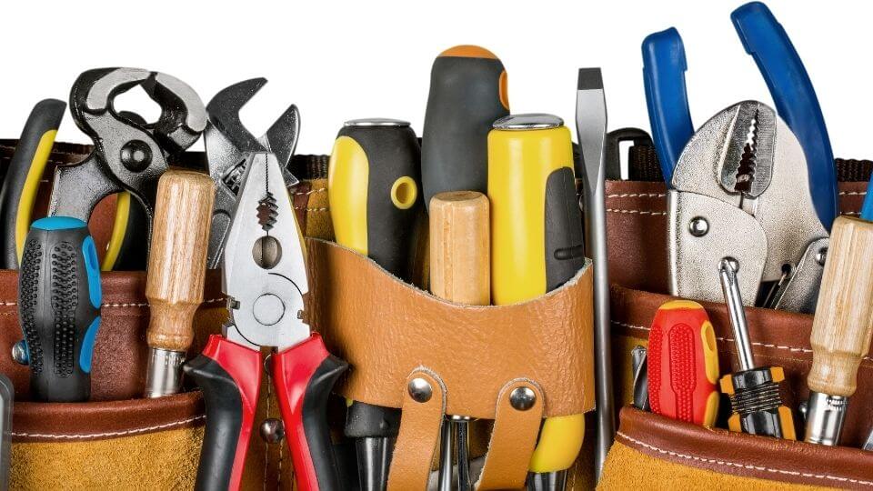 a bunch of tools in a tan tool belt